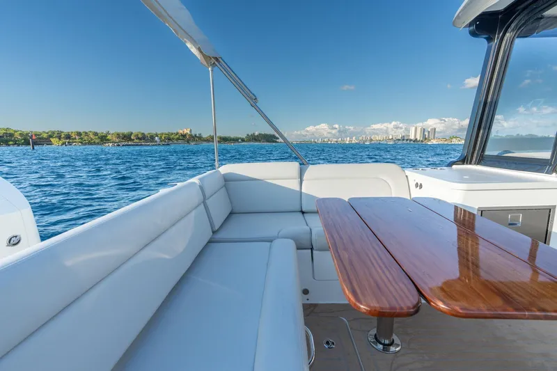 In-stock 2026 Mjm 3-053 Yacht Photos Pics Luxurious MJM 3 boat interior, 2026 model, with elegant seating and wooden table on open water.