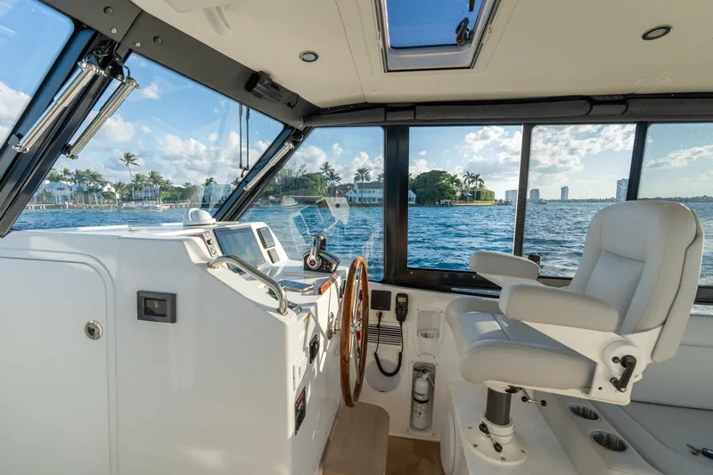 In-stock 2026 Mjm 3-053 Yacht Photos Pics Interior of 2026 MJM 3 boat with helm, white captain's chair, and ocean view.