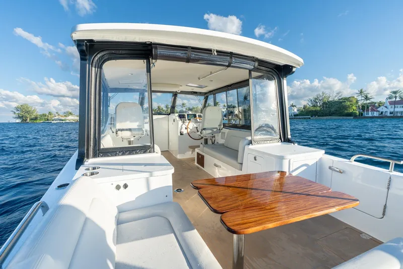In-stock 2026 Mjm 3-053 Yacht Photos Pics 2026 MJM 3 boat interior with wooden table, scenic water view, and clear skies.