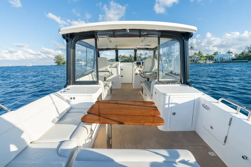 In-stock 2026 Mjm 3-053 Yacht Photos Pics Luxurious 2026 MJM 3 boat interior with seating and table on a sunny day.