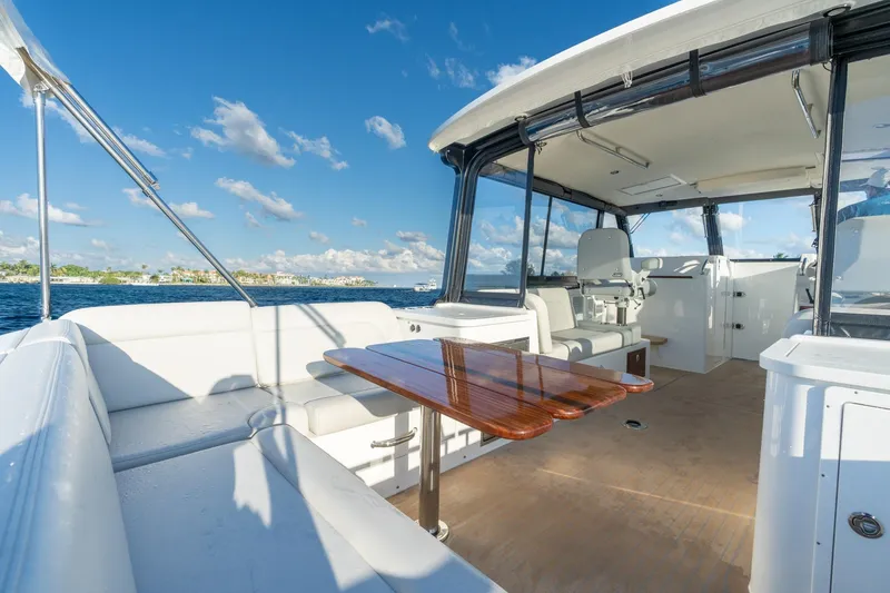 In-stock 2026 Mjm 3-053 Yacht Photos Pics Luxurious 2026 MJM 3 yacht interior with seating and table, overlooking serene waters.