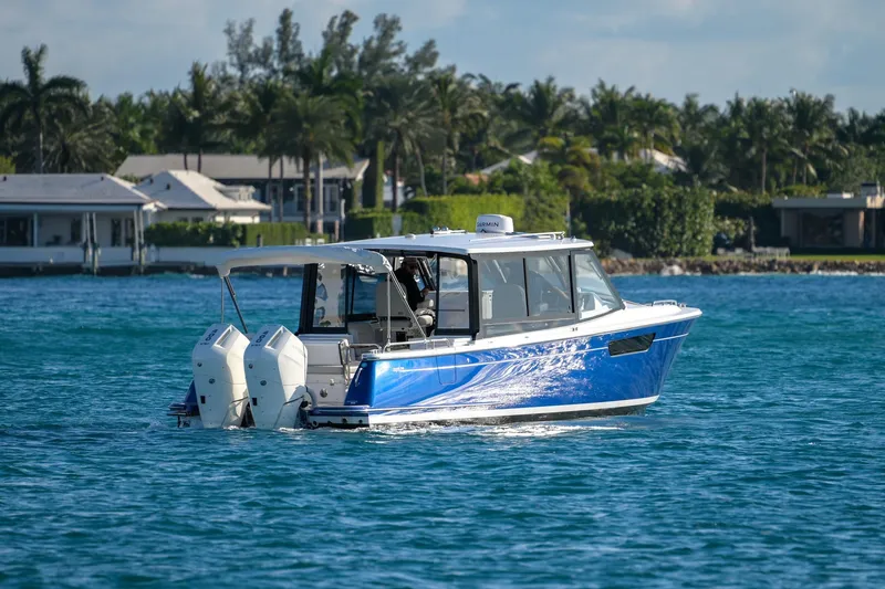 In-stock 2026 Mjm 3-053 Yacht Photos Pics 2026 MJM 3 boat cruising on a sunny day near waterfront homes.