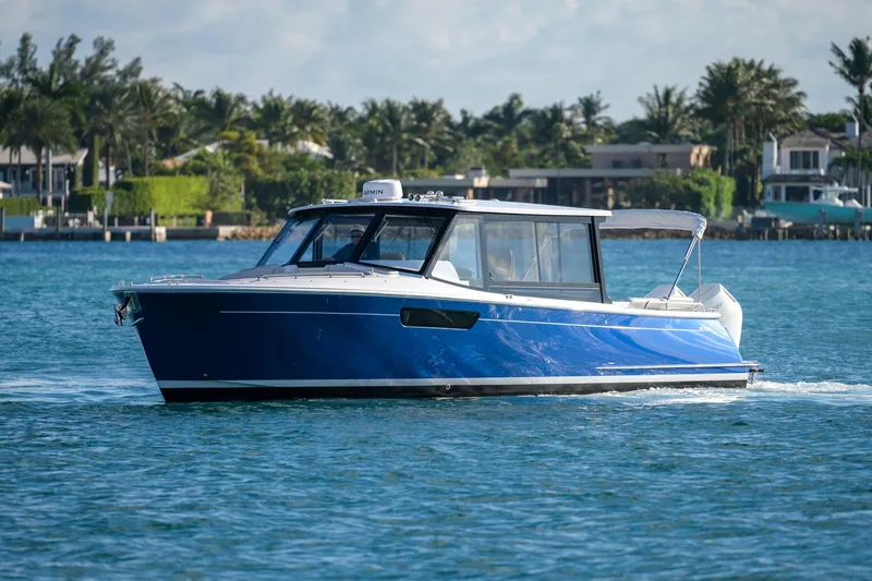 In-stock 2026 Mjm 3-053 Yacht Photos Pics 2026 MJM 3 boat cruising on a sunny day near a tropical shoreline.