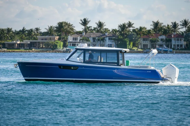 In-stock 2026 Mjm 3-053 Yacht Photos Pics 2026 MJM 3 boat cruising on blue water near luxury waterfront homes.