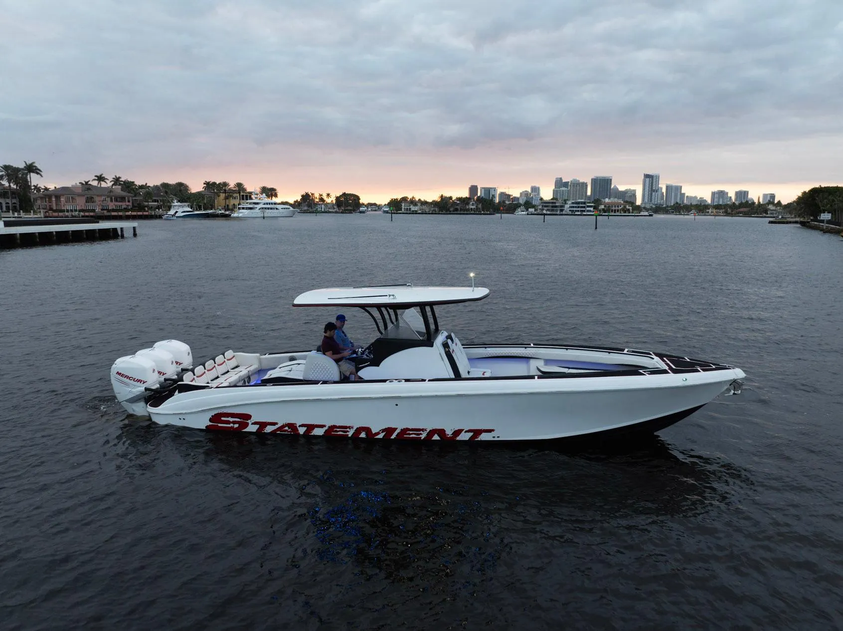 Statement 380 Open 2017 boat on water with city skyline in background.