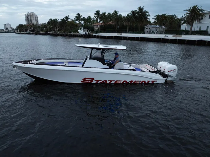 Heavy Metal Yacht Photos Pics 2017 Statement 380 Open boat cruising on a calm waterway, surrounded by palm trees.