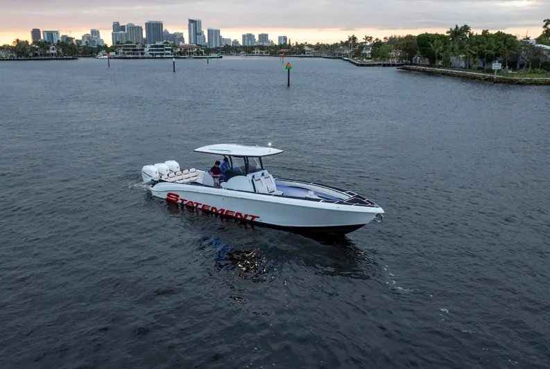 Heavy Metal Yacht Photos Pics Statement 380 Open 2017 boat cruising near city skyline on calm waters.