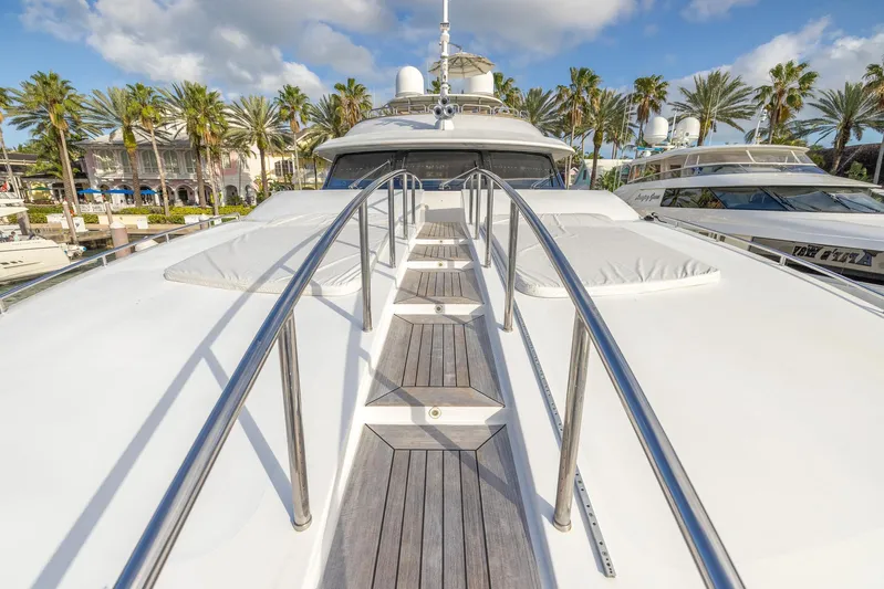 Benetti Classic Yacht Photos Pics 2008 Benetti Classic yacht deck with wooden walkway and railings, docked near palm trees.