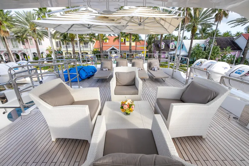 Benetti Classic Yacht Photos Pics Luxurious deck of 2008 Benetti Classic yacht with elegant seating and tropical backdrop.