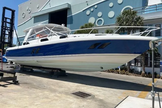  Yacht Photos Pics 2017 Intrepid 475 Sport Yacht in dry dock, blue and white hull, modern design.