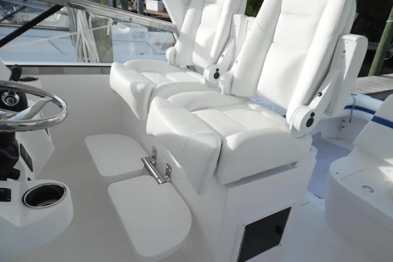  Yacht Photos Pics Luxury seating on 2017 Intrepid 475 Sport Yacht, featuring white leather captain's chairs.