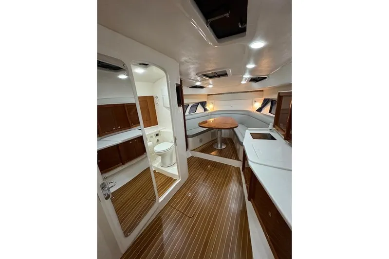  Yacht Photos Pics Luxurious interior of 2017 Intrepid 475 Sport Yacht with wood flooring and modern amenities.