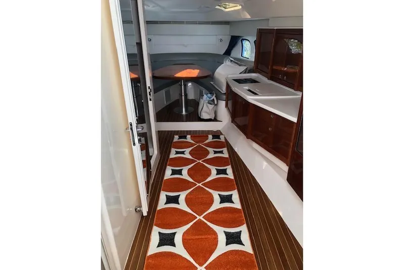  Yacht Photos Pics Interior of 2017 Intrepid 475 Sport Yacht with modern design and vibrant rug.