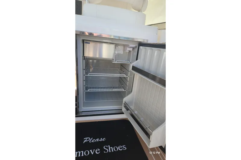  Yacht Photos Pics Open refrigerator on 2017 Intrepid 475 Sport Yacht with "Please Remove Shoes" mat.