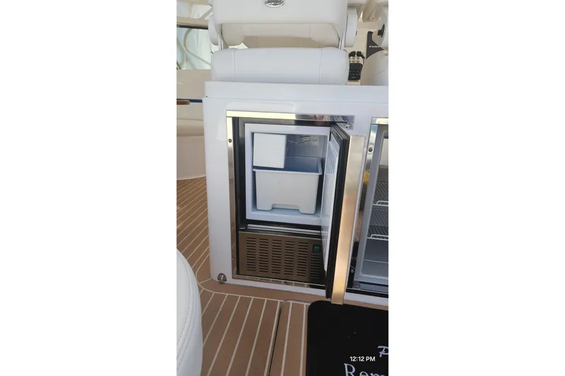 Yacht Photos Pics 2017 Intrepid 475 Sport Yacht interior with open mini fridge on teak flooring.