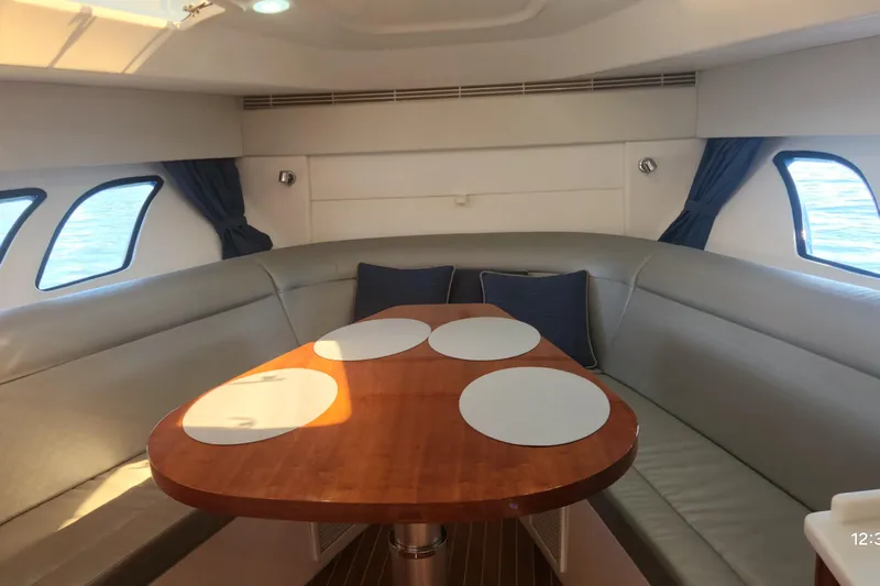  Yacht Photos Pics Interior of 2017 Intrepid 475 Sport Yacht with elegant dining area and curved seating.