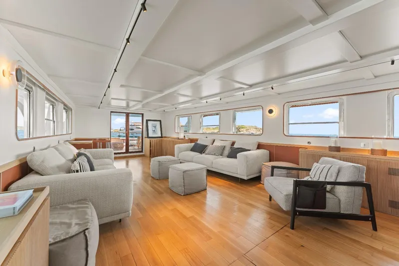 Daylami Yacht Photos Pics Luxurious interior of a 1972 Benetti Yachts Classic, featuring elegant seating and panoramic windows.