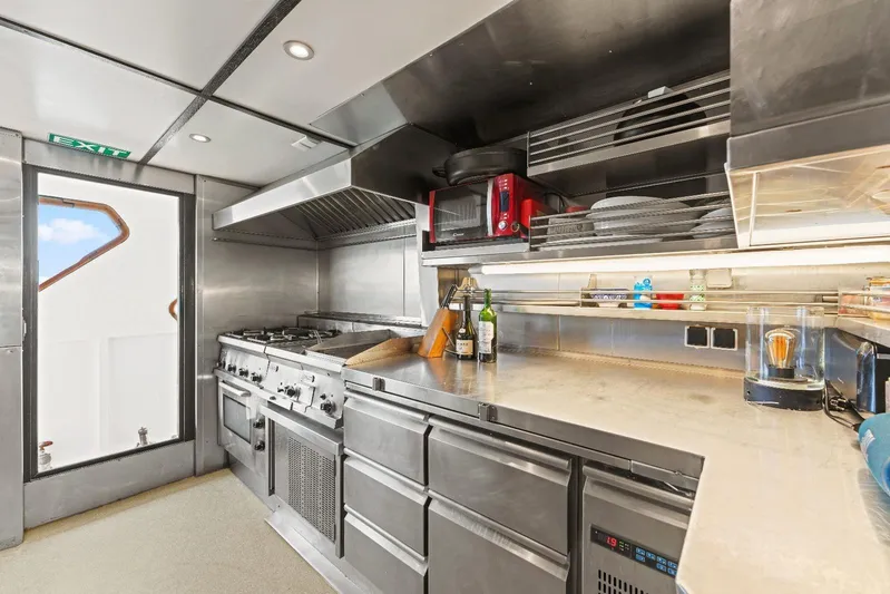 Daylami Yacht Photos Pics 1972 Benetti Yachts Classic kitchen with stainless steel appliances and modern design.