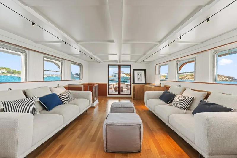 Daylami Yacht Photos Pics Luxurious interior of 1972 Benetti Yachts Classic, featuring elegant sofas and scenic ocean views.