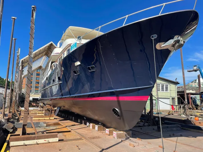 Talos Yacht Photos Pics 1983 Broward 92 Flushdeck Pilothouse yacht in dry dock, showcasing sleek design and craftsmanship.