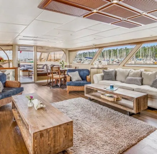 Talos Yacht Photos Pics Luxurious 1983 Broward 92 Flushdeck Pilothouse yacht interior with elegant seating and wooden accents.
