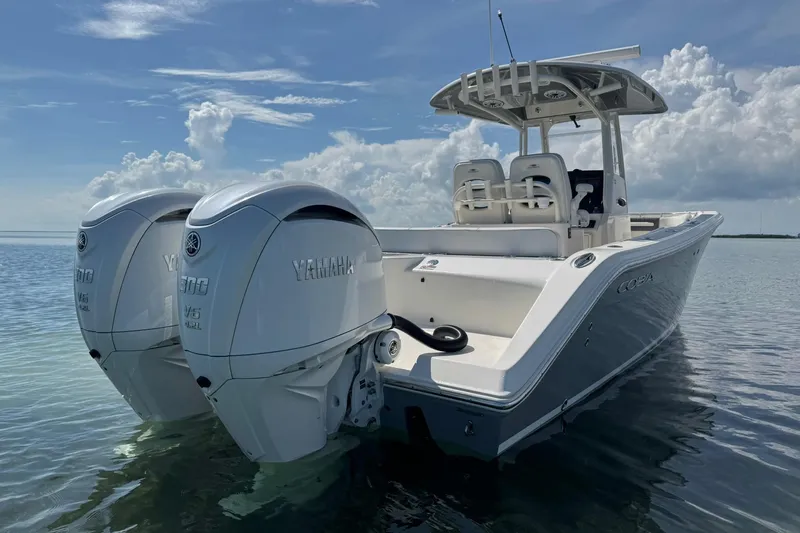  Yacht Photos Pics 2023 Cobia 280 Center Console boat with twin Yamaha engines on calm water.