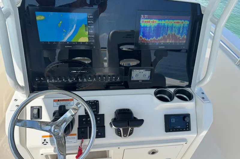  Yacht Photos Pics 2023 Cobia 280 Center Console dashboard with Garmin displays and steering wheel.