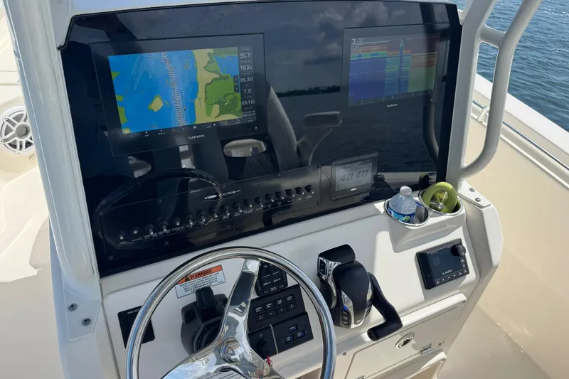  Yacht Photos Pics 2023 Cobia 280 Center Console dashboard with Garmin displays and steering wheel.