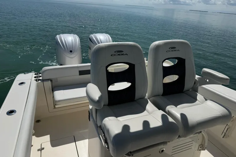  Yacht Photos Pics 2023 Cobia 280 Center Console boat with dual engines and comfortable seating on open water.