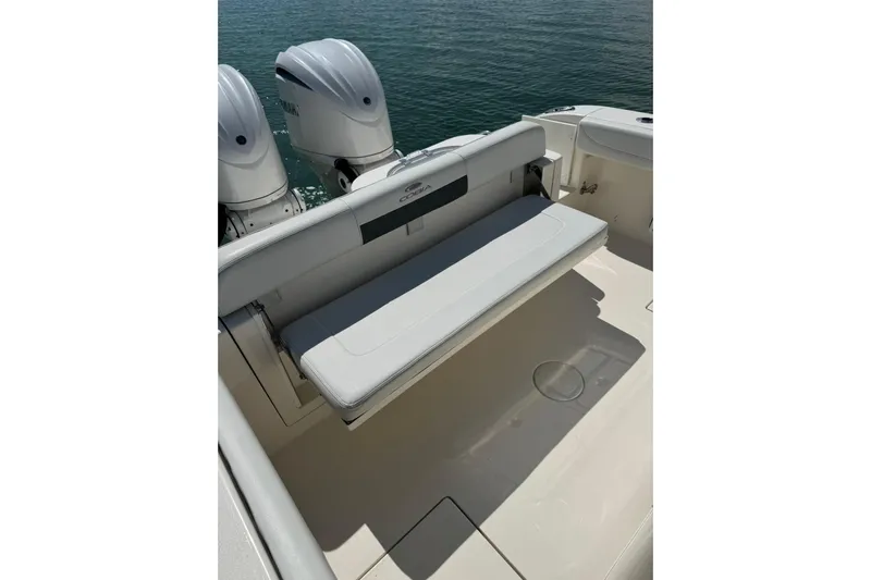  Yacht Photos Pics 2023 Cobia 280 Center Console boat with dual outboard engines and foldable rear seat.