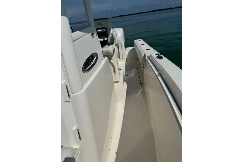  Yacht Photos Pics 2023 Cobia 280 Center Console boat deck with sleek design and ocean backdrop.