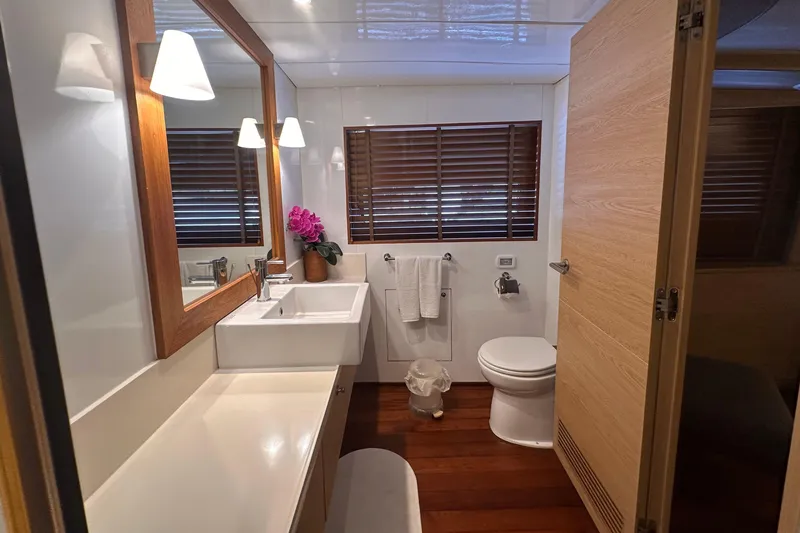 Celebrity Yacht Photos Pics Luxurious yacht bathroom with modern fixtures, wooden accents, and elegant lighting. Ses Yachts custom 2001.