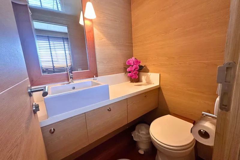 Celebrity Yacht Photos Pics Luxurious yacht bathroom with wooden decor, modern sink, and elegant lighting. Ses Yachts custom model, 2001.