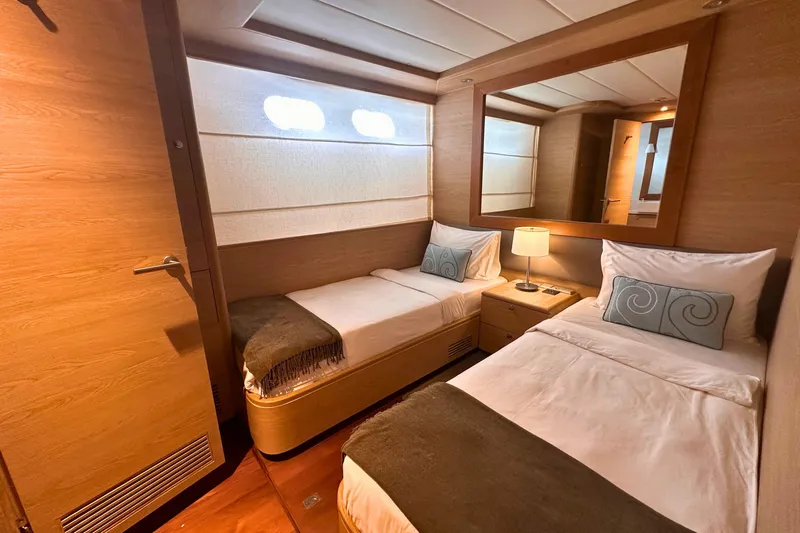 Celebrity Yacht Photos Pics Luxurious twin cabin interior on 2001 Ses Yachts custom model, featuring elegant wood finishes.