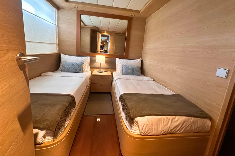 Celebrity Yacht Photos Pics Luxurious twin cabin interior on 2001 Ses Yachts custom model, featuring elegant wood paneling.