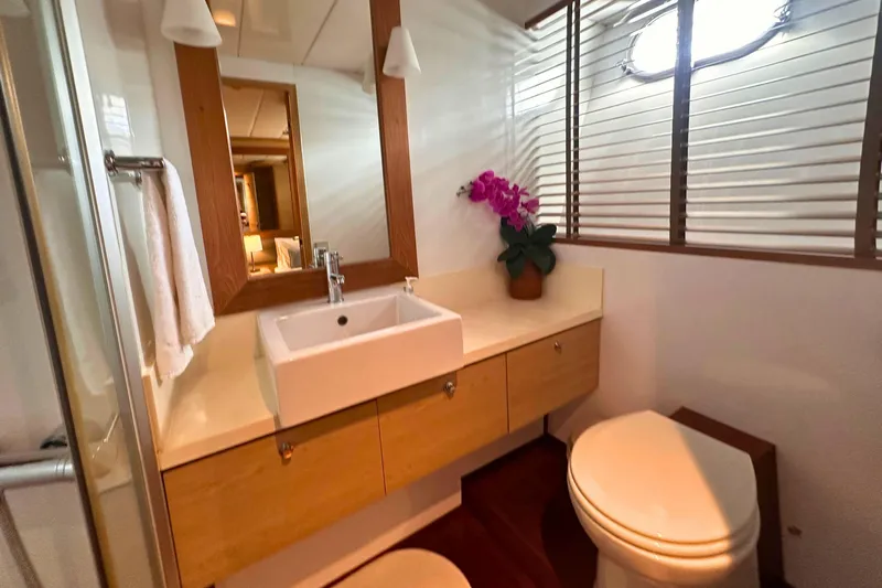 Celebrity Yacht Photos Pics Luxurious yacht bathroom with modern sink, wooden accents, and decorative orchid. Ses Yachts custom, 2001.