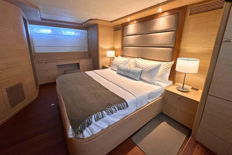 Celebrity Yacht Photos Pics Luxurious bedroom interior of 2001 Ses Yachts custom model with elegant wood finish.
