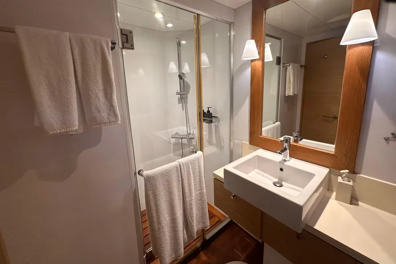 Celebrity Yacht Photos Pics Luxurious yacht bathroom with modern sink, shower, and wooden accents, Ses Yachts custom 2001.