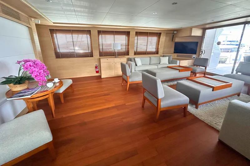 Celebrity Yacht Photos Pics Luxurious yacht interior with modern furniture, wooden flooring, and vibrant pink orchids. Ses Yachts custom, 2001.