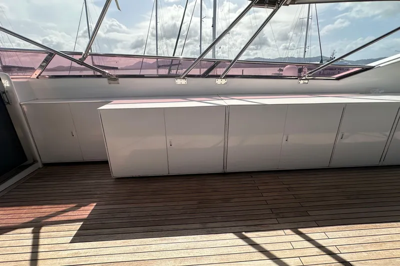 Celebrity Yacht Photos Pics Spacious deck of 2001 Ses Yachts custom model with wooden flooring and storage cabinets.