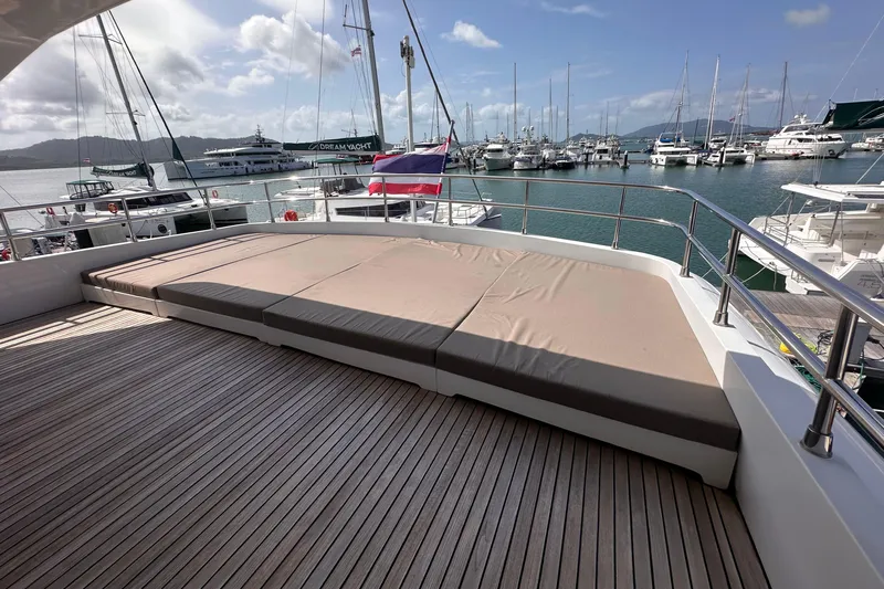 Celebrity Yacht Photos Pics Luxurious 2001 Ses Yachts custom deck with sunbed, overlooking marina with sailboats.