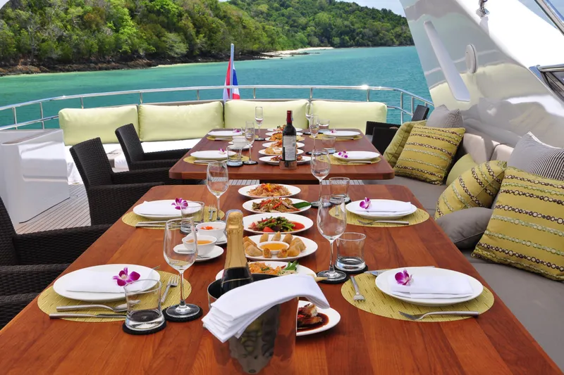 Celebrity Yacht Photos Pics Luxurious dining setup on a 2001 Ses Yachts custom yacht, overlooking serene turquoise waters.