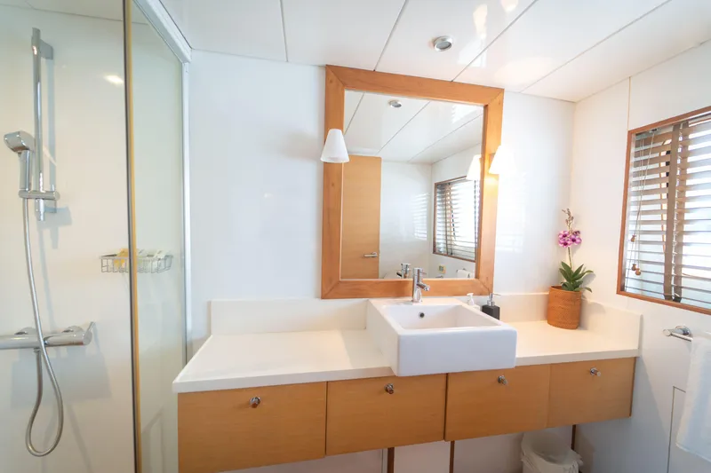 Celebrity Yacht Photos Pics Luxurious yacht bathroom with modern sink, shower, and wooden accents, Ses Yachts custom 2001.