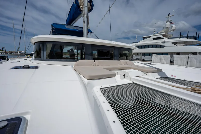 Starry Night Yacht Photos Pics 2022 Lagoon 46 catamaran with spacious deck and netting, docked at marina.