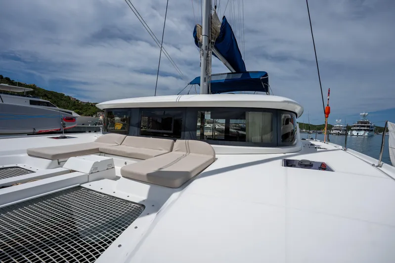 Starry Night Yacht Photos Pics 2022 Lagoon 46 catamaran with spacious deck and seating, docked under a cloudy sky.