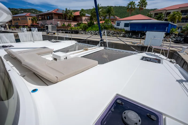 Starry Night Yacht Photos Pics 2022 Lagoon 46 catamaran docked, featuring spacious deck and sunbathing area.