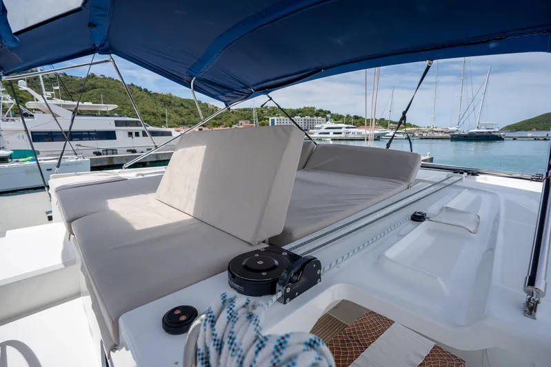 Starry Night Yacht Photos Pics 2022 Lagoon 46 catamaran with cushioned seating, docked in a marina.