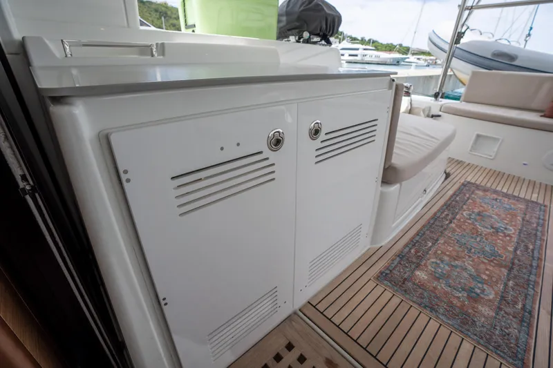 Starry Night Yacht Photos Pics 2022 Lagoon 46 yacht interior with storage cabinets and a patterned rug.