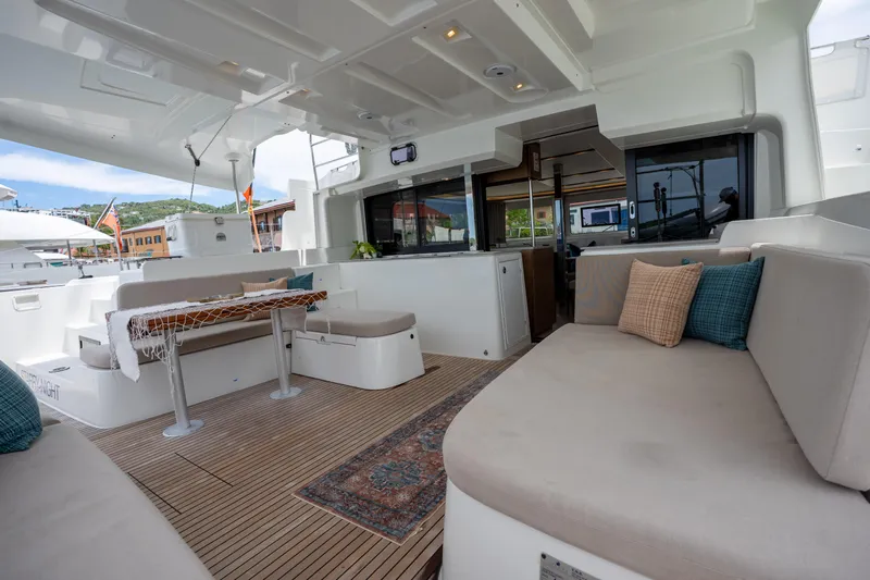 Starry Night Yacht Photos Pics Spacious deck of 2022 Lagoon 46 catamaran with comfortable seating and elegant decor.
