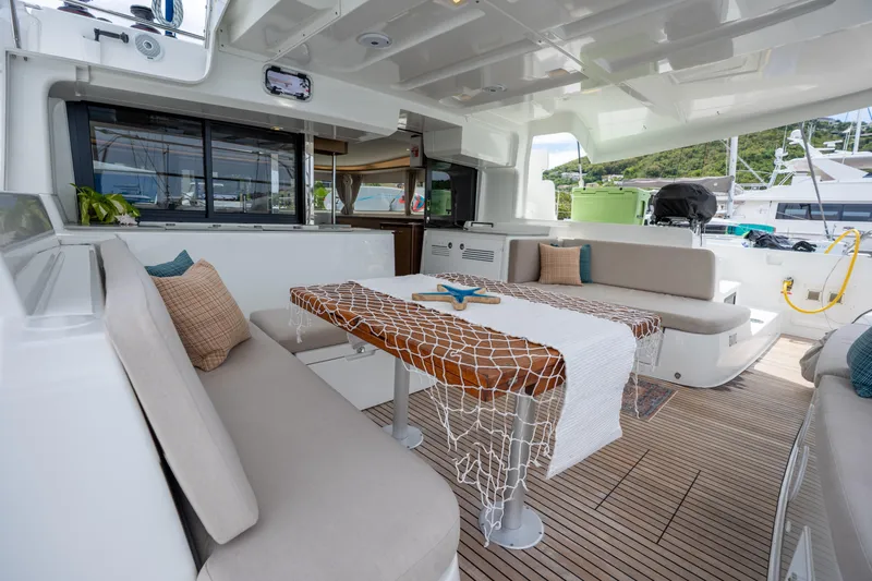Starry Night Yacht Photos Pics Luxurious Lagoon 46 catamaran interior, featuring elegant seating and a stylish dining area, 2022 model.